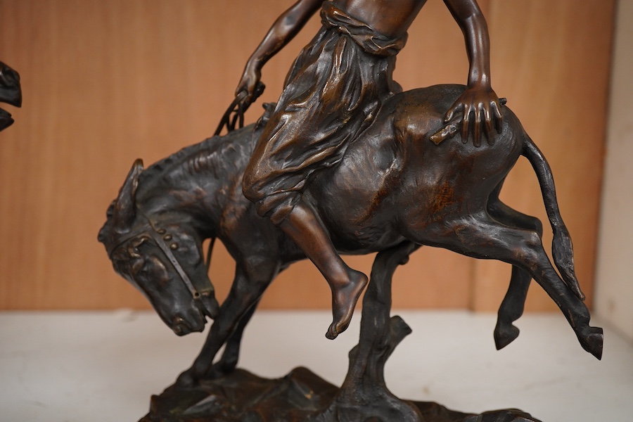 After Paul Aichele (1859-1910), a pair of bronze figures of Arab boys riding donkeys, 23cm